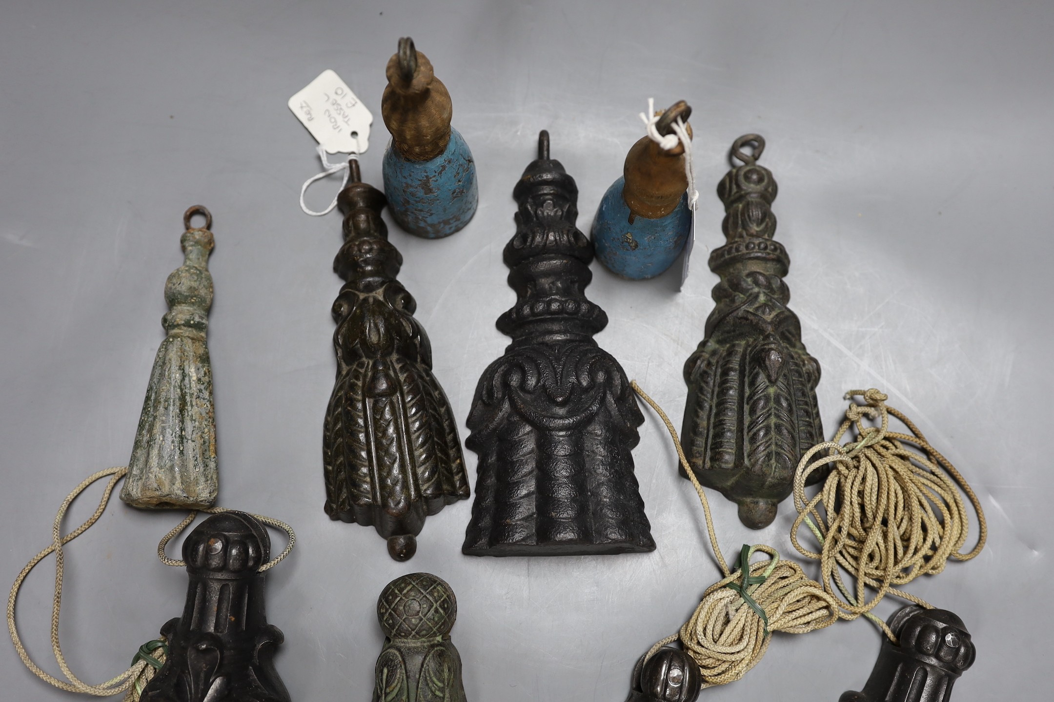 A mixed collection of cast iron tasselled weights